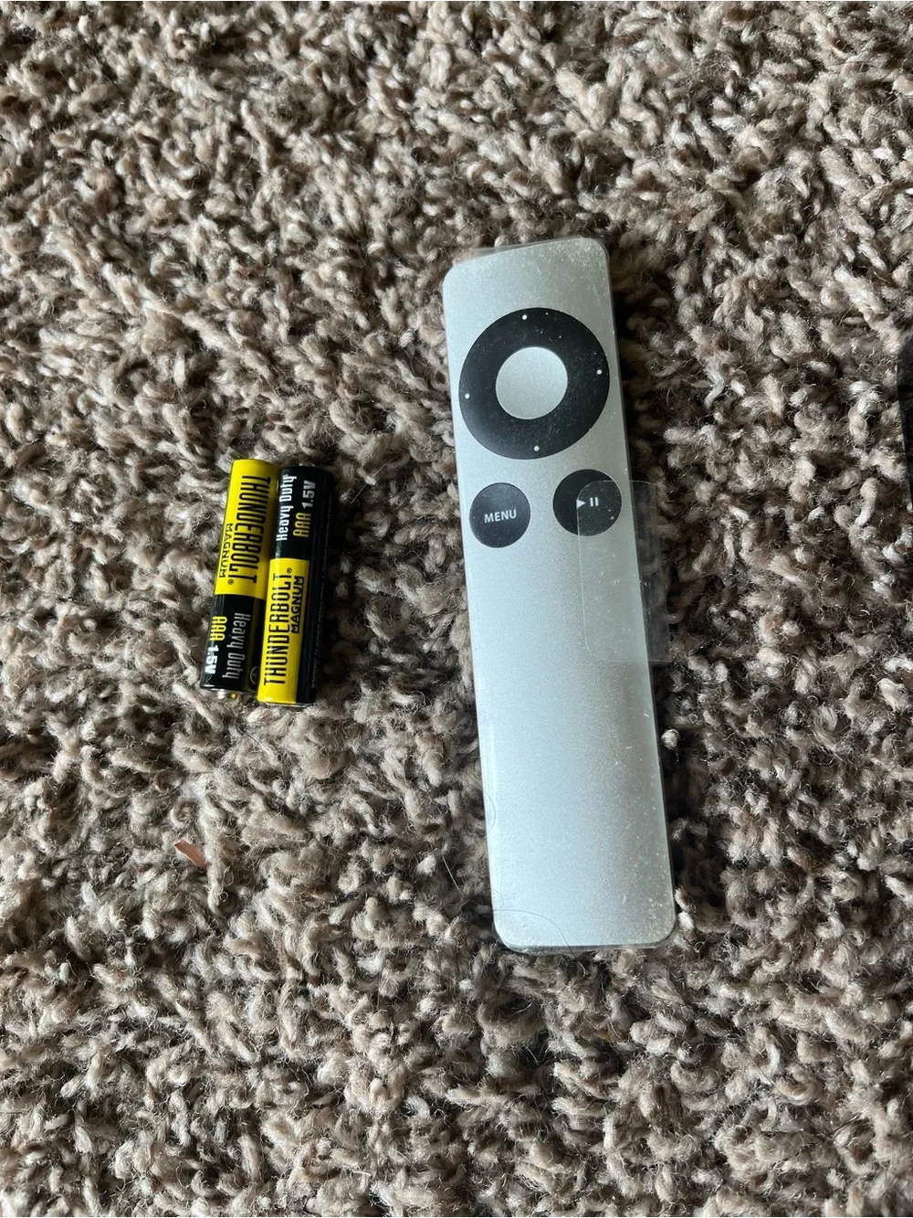 Apple TV with Silver Remote and Black Power Cable